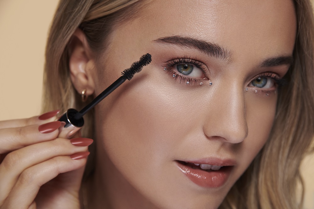 Woman applies mascara