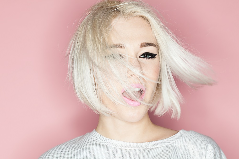 Female model swinging blonde bob haircut side to side
