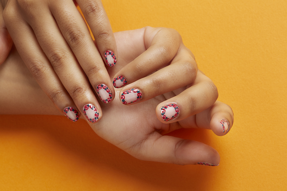 hand model with floral border nail art