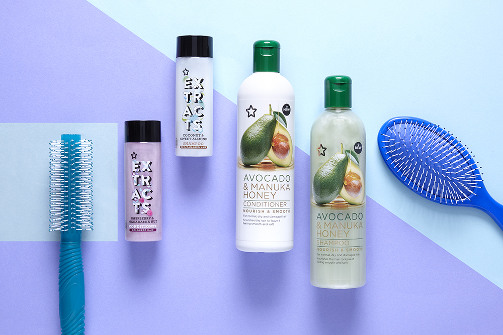 Flat lay of shampoos, conditioners and brushes for dry hair