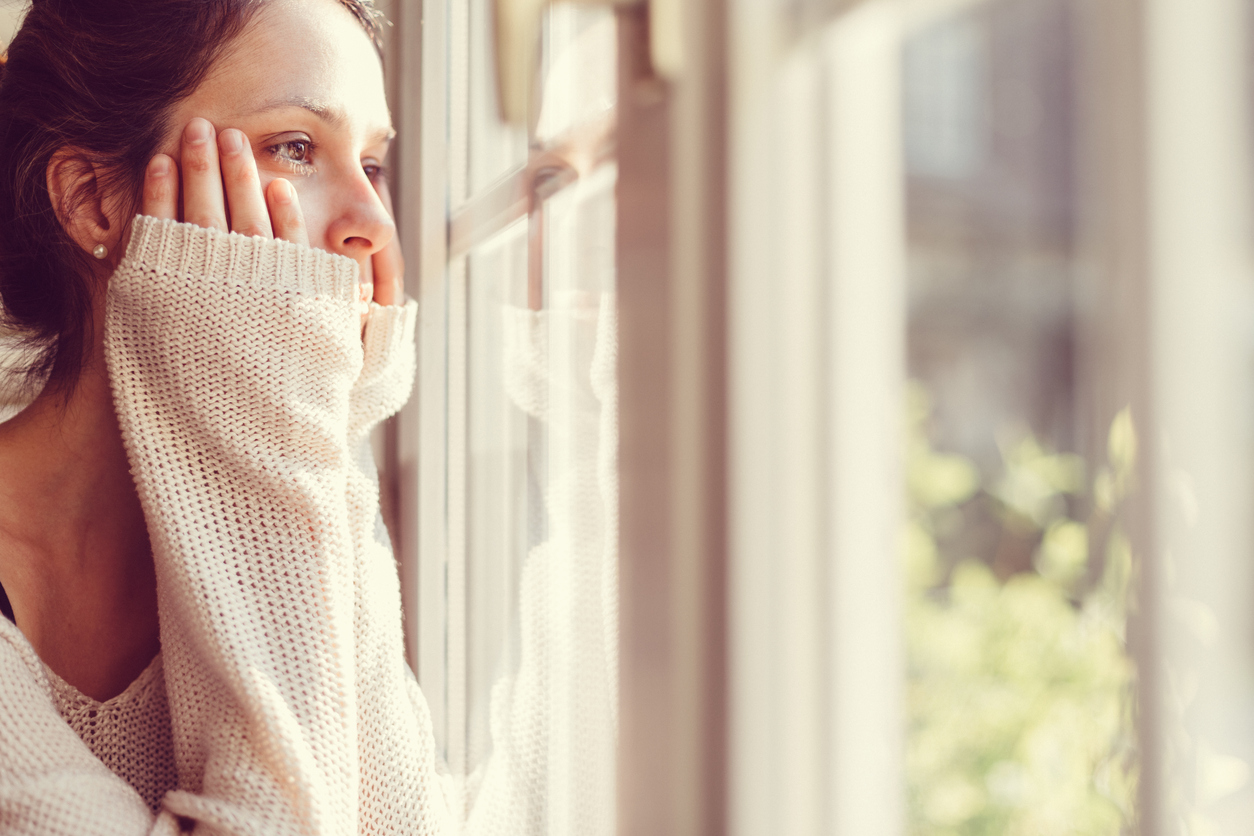 Thoughtful woman looking out of the window