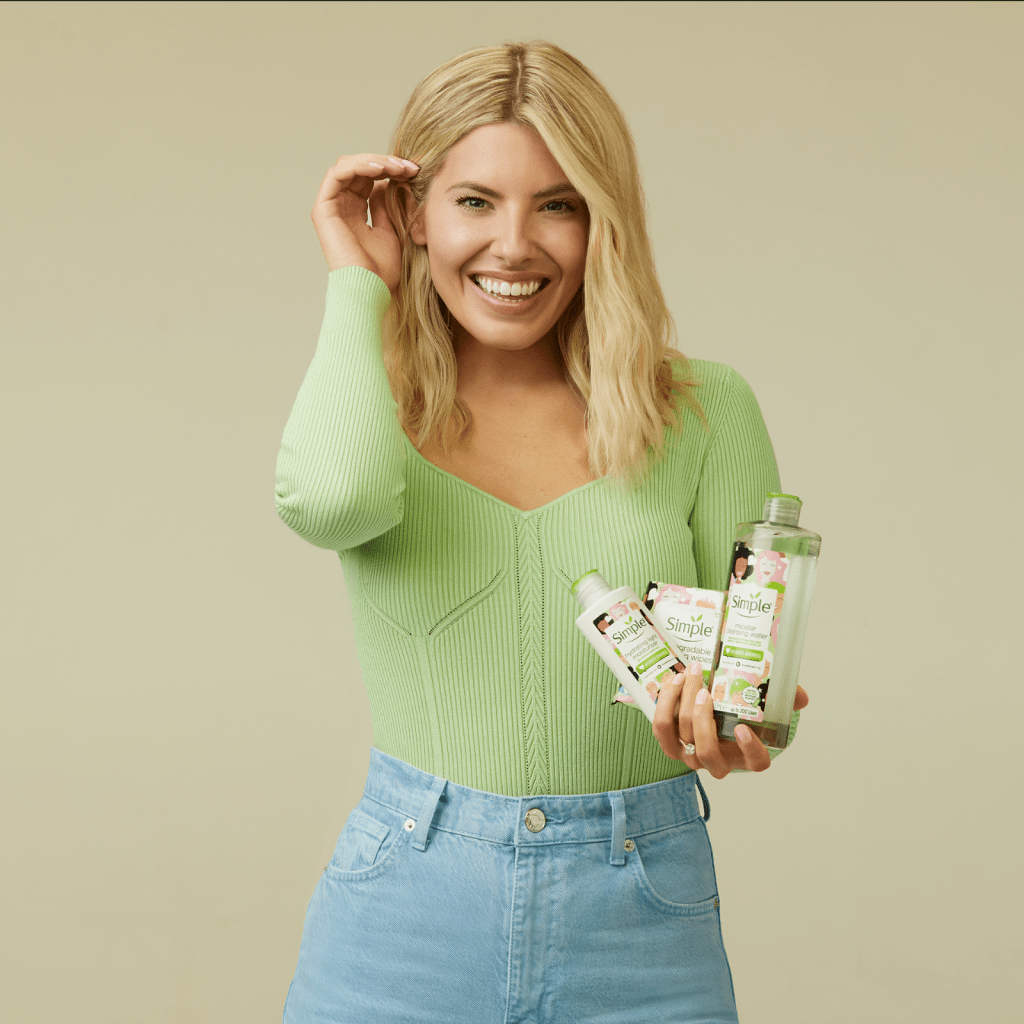 Blonde woman smiling and holding the 3 products being discussed