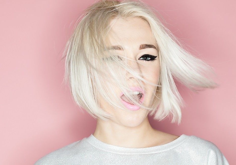 Female model swinging blonde bob haircut side to side